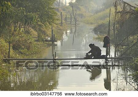 "Woman washing laundry in a channel, Nyaung Shwe, Inle-See, Shan State, Myanmar, Burma, Asia" View Large Photo Image Stock Photograph - "Woman washing laundry in a channel, Nyaung Shwe, Inle-See, Shan State, Myanmar, Burma, Asia". Fotosearch