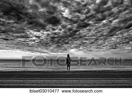 "Woman wearing a black dress standing by the sea, moody clouds, Cavallino, Jesolo, Venedig, Italy, Europe" View Large Photo Image Stock Photo - "Woman wearing a black dress standing by the sea, moody clouds, Cavallino, Jesolo, Venedig, Italy, Europe". Fotosearch