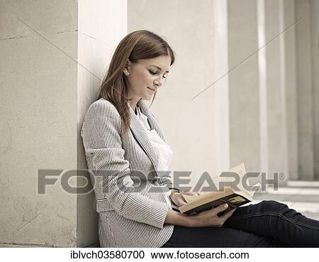"Woman wearing a business suit leaning against a wall and reading a book, Innsbruck, Tyrol, Austria, Europe" View Large Photo Image Stock Image - "Woman wearing a business suit leaning against a wall and reading a book, Innsbruck, Tyrol, Austria, Europe". Fotosearch