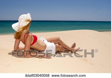 "Woman wearing a hat and a bikini, sunbathing on a sandy beach, Sotavento, Costa Bahia, Costa Calma, Fuerteventura, Canary Islands, Spain, Europe" View Large Photo Image Stock Photo - "Woman wearing a hat and a bikini, sunbathing on a sandy beach, Sotavento, Costa Bahia, Costa Calma, Fuerteventura, Canary Islands, Spain, Europe". Fotosearch
