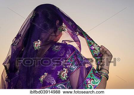 Stock Photo - "Woman wearing a purple sari, Vrindavan, Uttar Pradesh, India, Asia". Fotosearch