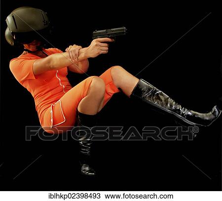 Woman wearing an orange jumpsuit falling backwards firing a gun View Large Photo Image Stock Image - Woman wearing an orange jumpsuit falling backwards firing a gun. Fotosearch