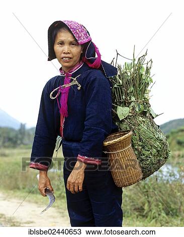 Stock Image - "Woman wearing traditional dress, mountain people, minority in China, Asia". Fotosearch