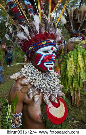 "Woman with a colourfully decorated costume and face paint is celebrating at the traditional Sing Sing gathering in the highlands, Paya, Papua New Guinea, Oceania" View Large Photo Image Picture - "Woman with a colourfully decorated costume and face paint is celebrating at the traditional Sing Sing gathering in the highlands, Paya, Papua New Guinea, Oceania". Fotosearch