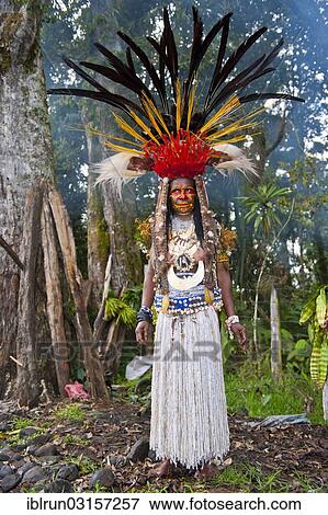 "Woman with a huge headdress, colourful decorations and face paint is celebrating at the traditional Sing Sing gathering in the Highlands, Paya, Papua New Guinea, Oceania" View Large Photo Image Stock Photo - "Woman with a huge headdress, colourful decorations and face paint is celebrating at the traditional Sing Sing gathering in the Highlands, Paya, Papua New Guinea, Oceania". Fotosearch