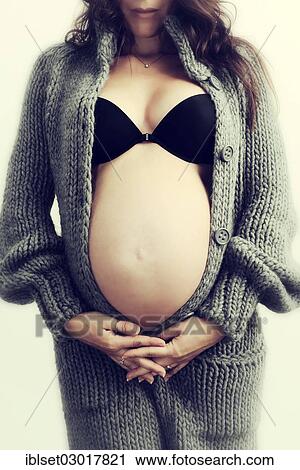 "Woman with a pregnant belly, in underwear and a cardigan" View Large Photo Image Stock Image - "Woman with a pregnant belly, in underwear and a cardigan". Fotosearch