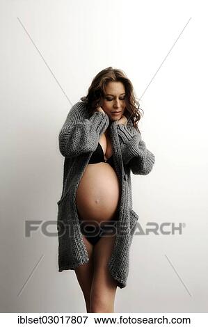 "Woman with a pregnant belly, in underwear and a cardigan" View Large Photo Image Stock Photo - "Woman with a pregnant belly, in underwear and a cardigan". Fotosearch