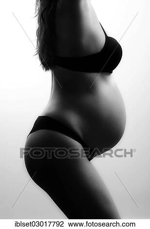 Woman with a pregnant belly in underwear View Large Photo Image Stock Image - Woman with a pregnant belly in underwear. Fotosearch
