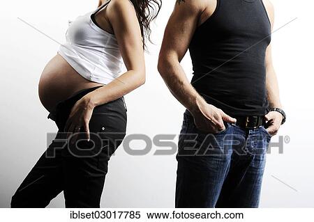 "Woman with a pregnant belly, man standing next to her" View Large Photo Image Stock Photography - "Woman with a pregnant belly, man standing next to her". Fotosearch