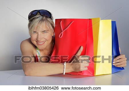 "Woman with colorful shopping bags, Germany, Europe" View Large Photo Image Stock Photograph - "Woman with colorful shopping bags, Germany, Europe". Fotosearch