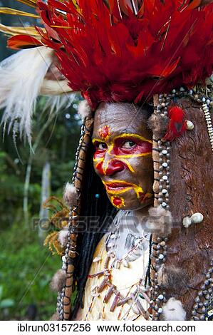 "Woman with colourful decorations and face paint is celebrating at the traditional Sing Sing gathering in the Highlands, Paya, Papua New Guinea, Oceania" View Large Photo Image Stock Photograph - "Woman with colourful decorations and face paint is celebrating at the traditional Sing Sing gathering in the Highlands, Paya, Papua New Guinea, Oceania". Fotosearch