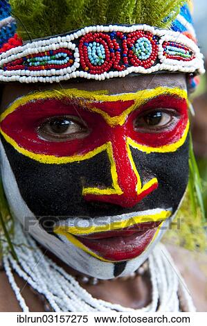 "Woman with colourful decorations and face paint is celebrating the traditional Sing Sing gathering in the highlands, Paya, Papua New Guinea, Oceania" View Large Photo Image Stock Photography - "Woman with colourful decorations and face paint is celebrating the traditional Sing Sing gathering in the highlands, Paya, Papua New Guinea, Oceania". Fotosearch