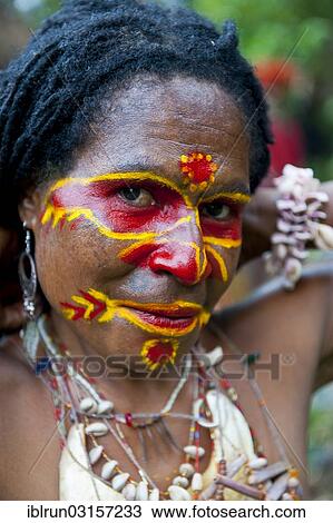 "Woman with colourful face paint is celebrating at the traditional Sing Sing gathering in the highlands, Paya, Papua New Guinea, Oceania" View Large Photo Image Stock Image - "Woman with colourful face paint is celebrating at the traditional Sing Sing gathering in the highlands, Paya, Papua New Guinea, Oceania". Fotosearch