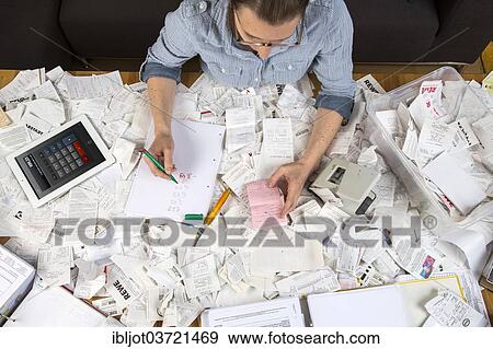 "Woman with documents, records, invoices and receipts for the tax return" View Large Photo Image Stock Photo - "Woman with documents, records, invoices and receipts for the tax return". Fotosearch
