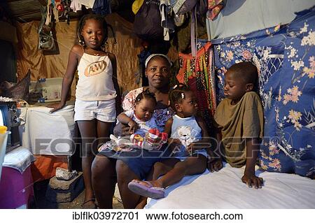 "Woman with four children in a shack, Camp Icare for earthquake refugees, Fort National, Port-au-Prince, Haiti, North America" View Large Photo Image Stock Image - "Woman with four children in a shack, Camp Icare for earthquake refugees, Fort National, Port-au-Prince, Haiti, North America". Fotosearch
