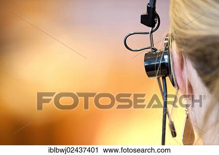 Stock Image - "Woman with headphones, simultaneous translation". Fotosearch