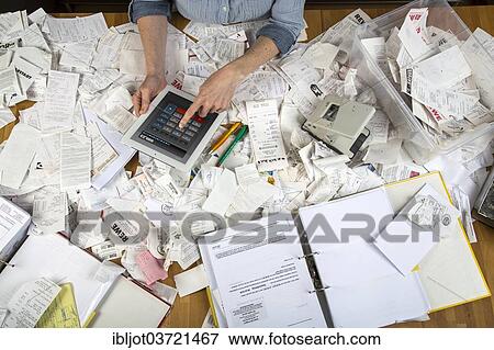 "Woman with invoices and receipts on a desk, for the tax return, calculating on a tablet PC" View Large Photo Image Stock Photo - "Woman with invoices and receipts on a desk, for the tax return, calculating on a tablet PC". Fotosearch