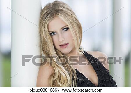 "Woman with long blond hair leaning against a column, portrait" View Large Photo Image Stock Photo - "Woman with long blond hair leaning against a column, portrait". Fotosearch