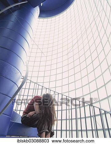 Woman with long hair sitting on the stairs of a staircase with glass blocks View Large Photo Image Stock Image - Woman with long hair sitting on the stairs of a staircase with glass blocks. Fotosearch