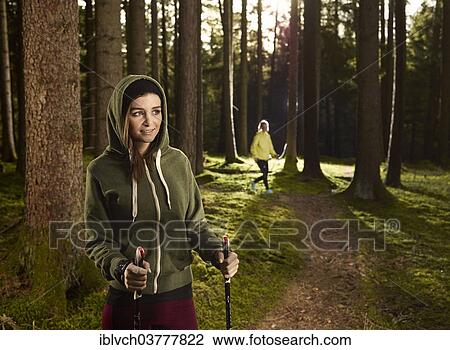 "Woman with Nordic Walking sticks in the forest, another woman jogging at back, Tyrol, Austria, Europe" View Large Photo Image Stock Image - "Woman with Nordic Walking sticks in the forest, another woman jogging at back, Tyrol, Austria, Europe". Fotosearch