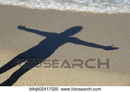 Woman with outstretched arms casting her shadow on the beach, Kathisma, Lefkas or Lefkada, Greece, Europe View Large Photo Image Stock Image - Woman with outstretched arms casting her shadow on the beach, Kathisma, Lefkas or Lefkada, Greece, Europe. Fotosearch