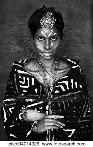 "Woman with painted face, flower on the head and blades of grass in the Hand" View Large Photo Image Stock Photo - "Woman with painted face, flower on the head and blades of grass in the Hand". Fotosearch