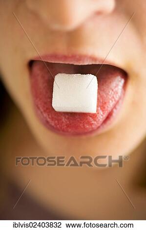 Woman with sugar cube on her tongue View Large Photo Image Stock Image - Woman with sugar cube on her tongue. Fotosearch