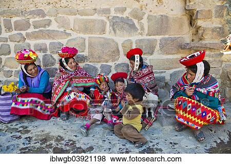 "Women and children in traditional dress of the Quechua Indians sitting on the floor in front of a wall, Ollantaytambo, Urubamba Valley, Peru, South America" View Large Photo Image Stock Photo - "Women and children in traditional dress of the Quechua Indians sitting on the floor in front of a wall, Ollantaytambo, Urubamba Valley, Peru, South America". Fotosearch