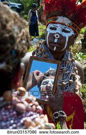 "Women applying make-up and face paint at the traditional sing-sing gathering, Hochland, Mount Hagen, Western Highlands Province, Papua New Guinea, Oceania" View Large Photo Image Stock Photograph - "Women applying make-up and face paint at the traditional sing-sing gathering, Hochland, Mount Hagen, Western Highlands Province, Papua New Guinea, Oceania". Fotosearch