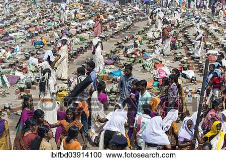 Stock Image - "Women cooking Prasad during the Pongala festival, Thiruvananthapuram, Kerala, India, Asia". Fotosearch