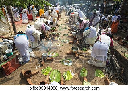 "Women cooking Prasad in the busy streets during the Pongala festival, Thiruvananthapuram, Kerala, India, Asia" View Large Photo Image Stock Photo - "Women cooking Prasad in the busy streets during the Pongala festival, Thiruvananthapuram, Kerala, India, Asia". Fotosearch