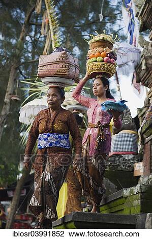 "Women delivering sacrficial offerings to a temple, Padang Tegal, Ubud, Bali, Indonesia, Asia" View Large Photo Image Stock Image - "Women delivering sacrficial offerings to a temple, Padang Tegal, Ubud, Bali, Indonesia, Asia". Fotosearch