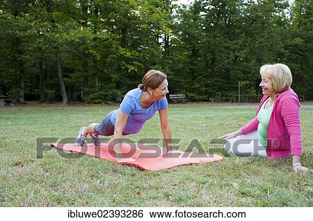 Stock Photograph - Women doing gymnastics outdoors. Fotosearch