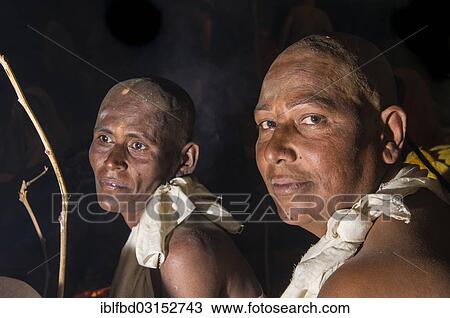 Stock Image - "Women during the initiation of new Jain nuns, during Kumbha Mela festival, at night, Allahabad, Uttar Pradesh, India, Asia". Fotosearch