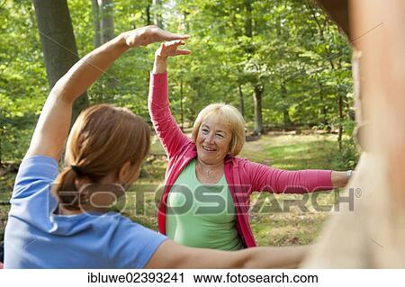 Women exercising on an outdoor fitness trail View Large Photo Image Stock Image - Women exercising on an outdoor fitness trail. Fotosearch