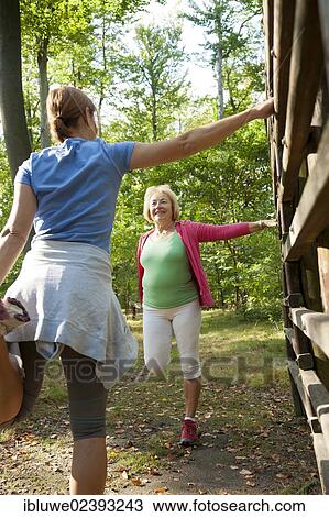 Women exercising on an outdoor fitness trail View Large Photo Image Stock Image - Women exercising on an outdoor fitness trail. Fotosearch