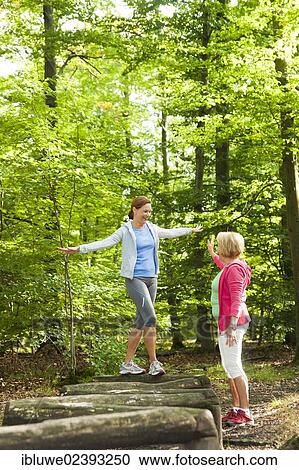 Stock Image - Women exercising on an outdoor fitness trail. Fotosearch