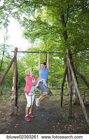 Women exercising on an outdoor fitness trail View Large Photo Image Stock Image - Women exercising on an outdoor fitness trail. Fotosearch