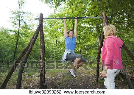 Women exercising on an outdoor fitness trail View Large Photo Image Stock Image - Women exercising on an outdoor fitness trail. Fotosearch