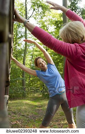 Women exercising on an outdoor fitness trail View Large Photo Image Stock Photo - Women exercising on an outdoor fitness trail. Fotosearch