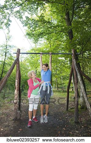 Women exercising on an outdoor fitness trail View Large Photo Image Stock Photo - Women exercising on an outdoor fitness trail. Fotosearch