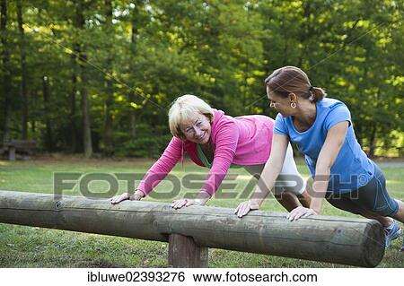 Women exercising on an outdoor fitness trail View Large Photo Image Stock Photograph - Women exercising on an outdoor fitness trail. Fotosearch
