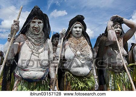 Stock Photo - "Women in colourfully decorated costumes with face and body paint at the traditional sing-sing gathering, Hochland, Mount Hagen, Western Highlands Province, Papua New Guinea, Oceania". Fotosearch