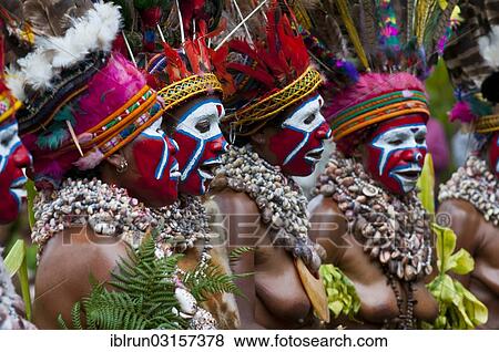 Stock Photo - "Women in colourfully decorated costumes with face paint are celebrating at the traditional Sing Sing gathering in the highlands, Paya, Papua New Guinea, Oceania". Fotosearch