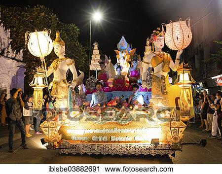 Stock Image - "Women in traditional costume travelling on a float, parade, Loi Krathong Festival of Lights, Loy, Chiang Mai, Northern Thailand, Thailand, Asia". Fotosearch