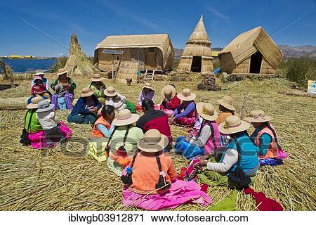 "Women of the Uro Indians sit in front of typical reed huts, floating islands made of totora reeds, Lake Titicaca, southern Peru, Peru, South America" View Large Photo Image Stock Image - "Women of the Uro Indians sit in front of typical reed huts, floating islands made of totora reeds, Lake Titicaca, southern Peru, Peru, South America". Fotosearch