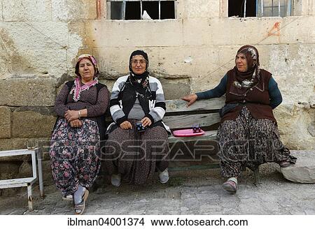 Picture - "Women sitting on a bench, Urgup, Nevsehir Province, Cappadocia, Central Anatolia Region, Anatolia, Turkey, Asia". Fotosearch