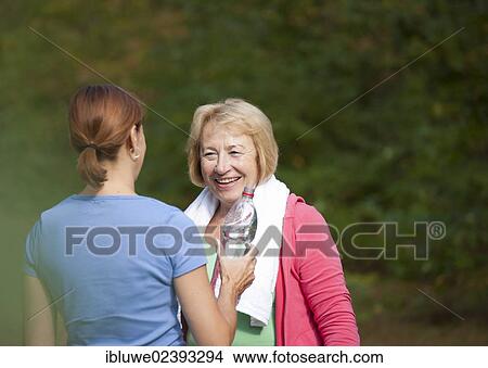 Women taking a break while doing sports outdoors View Large Photo Image Picture - Women taking a break while doing sports outdoors. Fotosearch