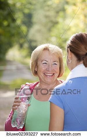Women taking a break while doing sports outdoors View Large Photo Image Stock Photo - Women taking a break while doing sports outdoors. Fotosearch