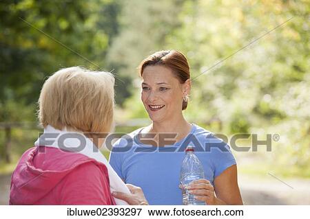 Women taking a break while doing sports outdoors View Large Photo Image Stock Photo - Women taking a break while doing sports outdoors. Fotosearch